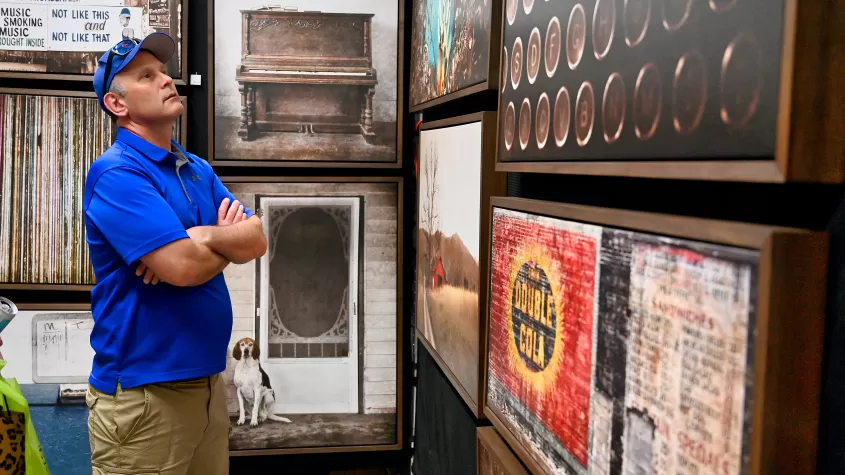 Attendee admiring an artist's work at ArtFest Fort Myers 2022