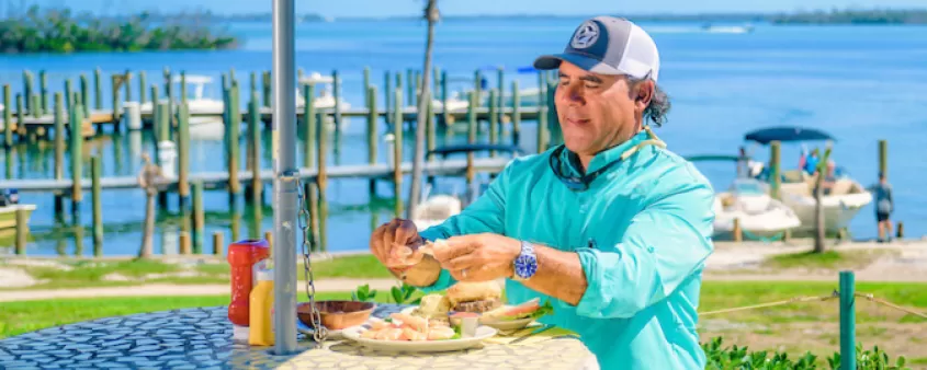 A man enjoys a meal at an outdoor table on Cabbage Key